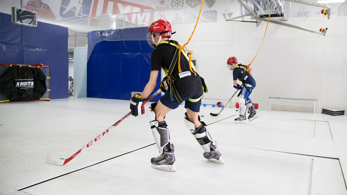 Hockey training facility with skating treadmill