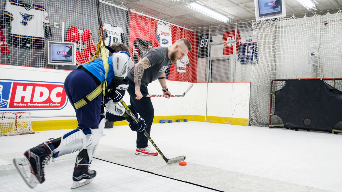 Hockey player training on skating treadmill at hockey facility